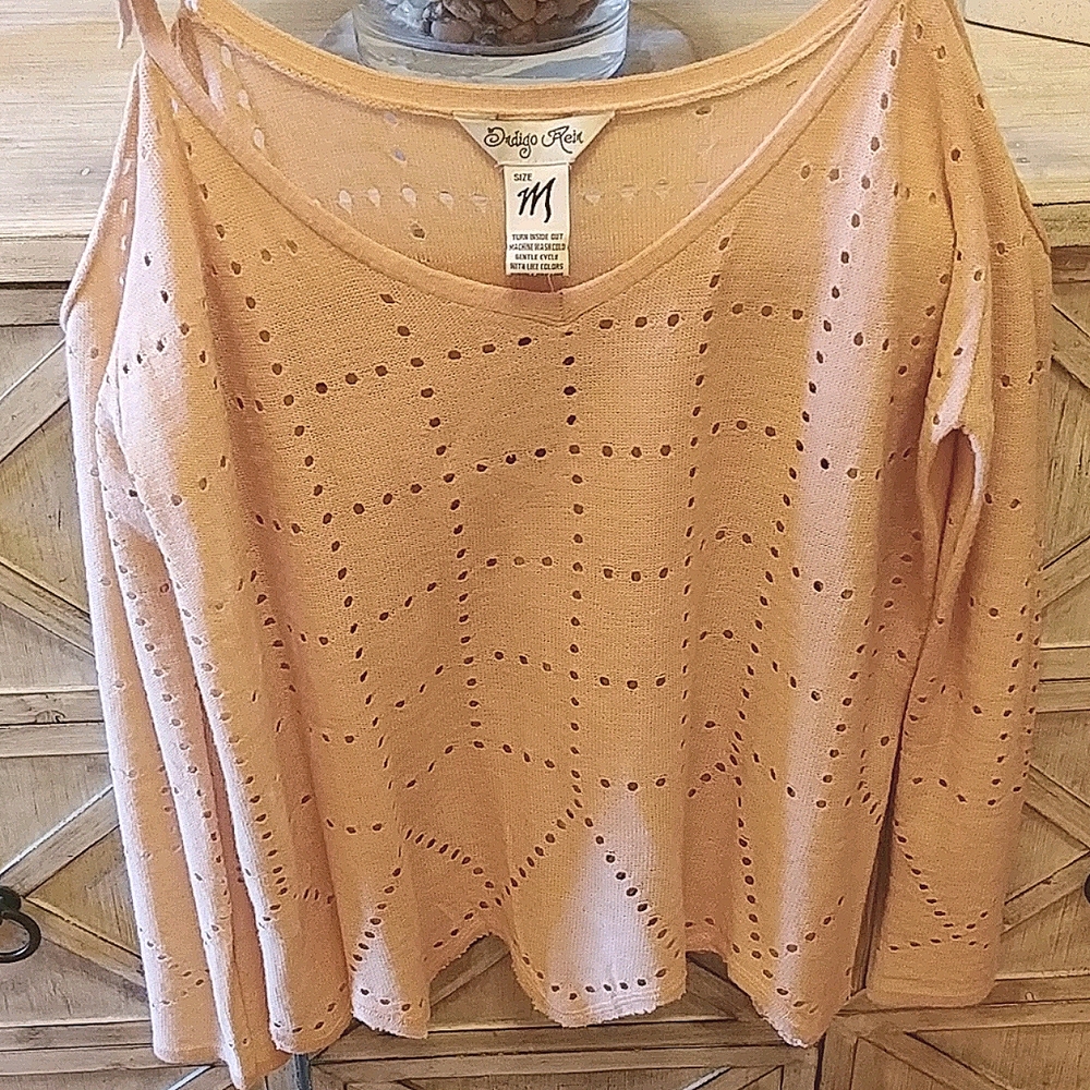Unique light weight shoulder cutout sweater.